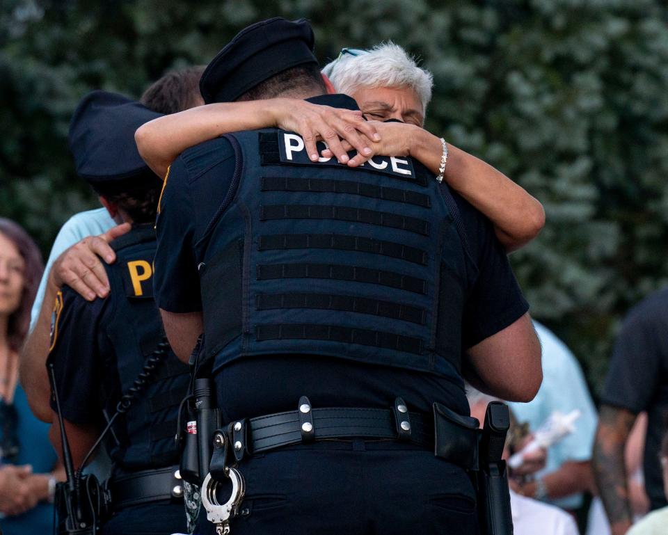Dahlia Galindez, Katie Seley's mother, hugging Upper Makefield Police Officer Gerry Russi at the vigil honoring both victims and survivors of the recent flash flooding in Upper Makefield at the 911 Memorial Garden of Reflection in Yardley on Sunday, July 23, 2023.