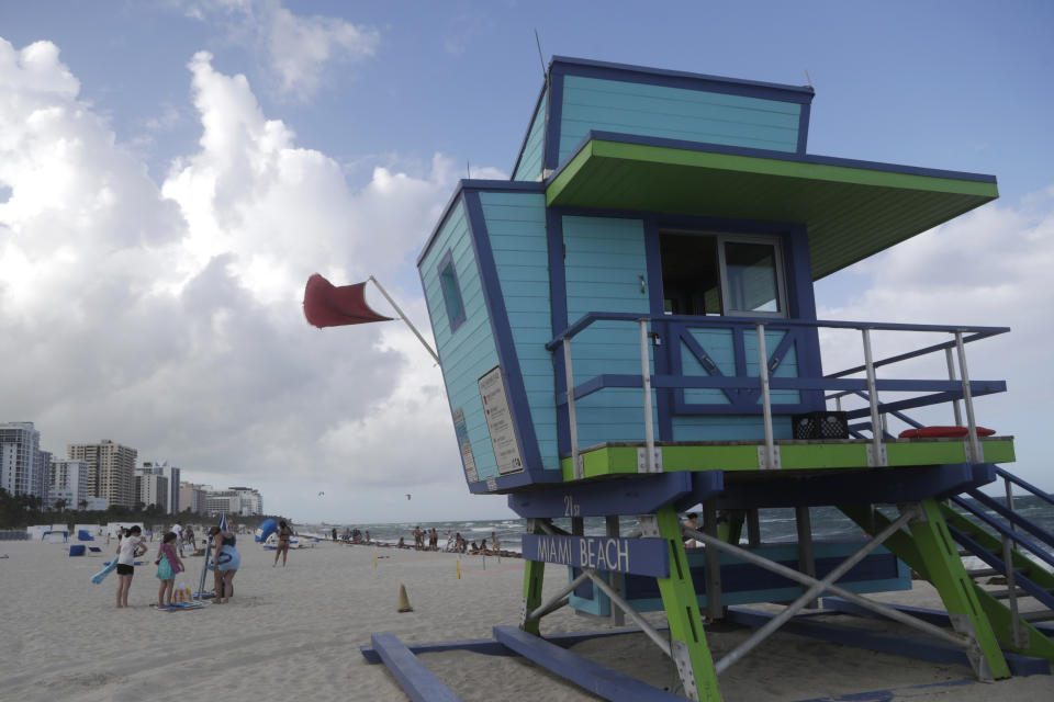 A red flag flies from a lifeguard station indicating high surf, Friday, July 31, 2020, in Miami Beach, Fla. Forecasters declared a hurricane warning for parts of the Florida coast Friday as Hurricane Isaias drenched the Bahamas on track for the U.S. East Coast. (AP Photo/Lynne Sladky)