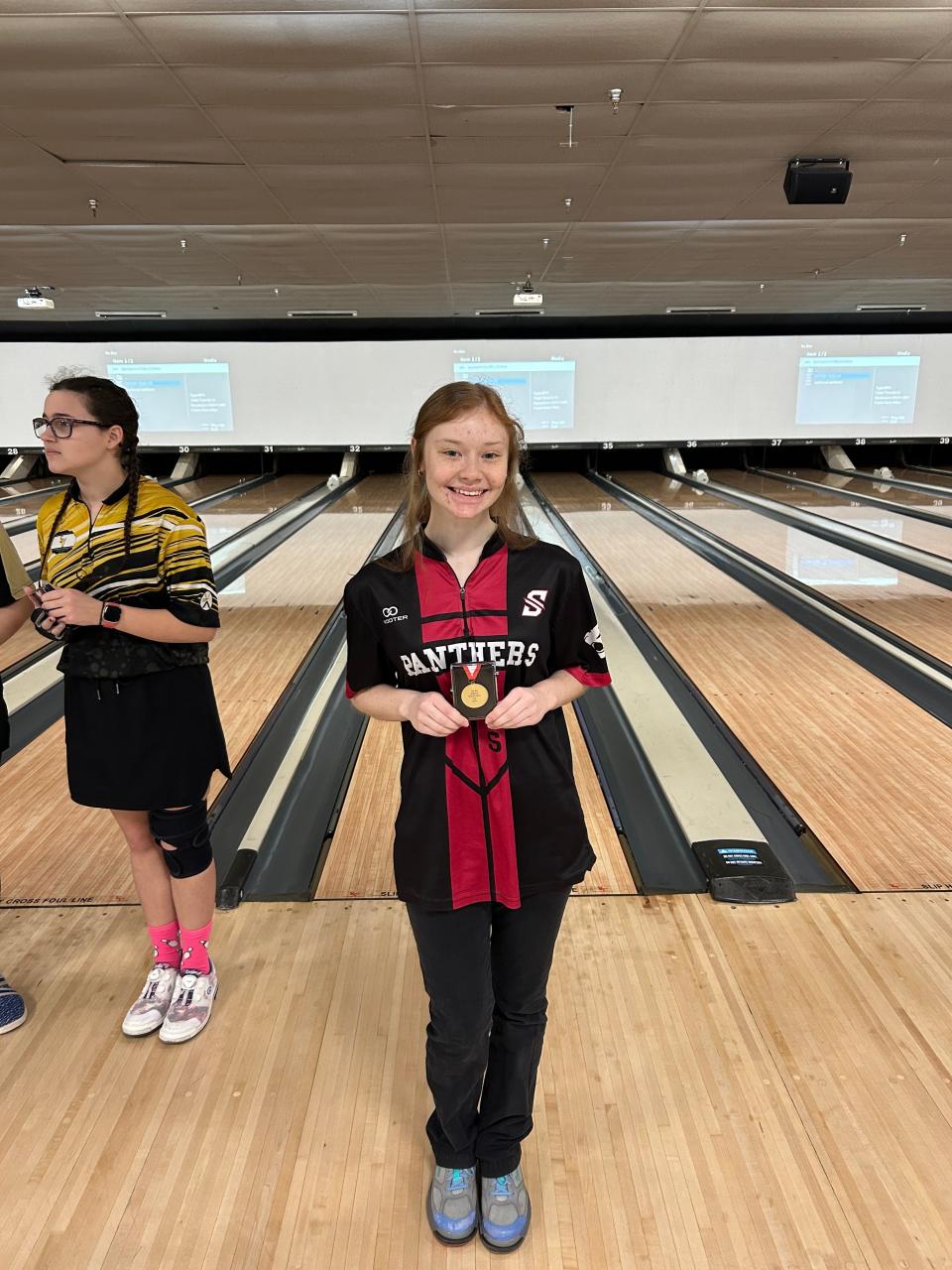 Southside girls bowling Cora Clontz poses with the medal for winning the AHSAA Class 1A-5A state individual title.