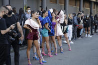 Young models wear creations by fashion student Nora Bourelly on a street outside Valentino women's Spring-Summer 2021 fashion show location, in Milan, Italy, Sunday, Sept. 27, 2020. (AP Photo/Luca Bruno).