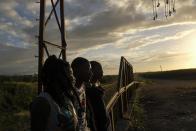 Young Haitian migrants hang out in the Batey La Lima community, an impoverished community surrounded by a massive sugarcane plantation in the coastal city of La Romana, Dominican Republic, Wednesday, Nov. 17, 2021. As the rest of the world closes its doors to Haitian migrants, the country that shares an island with Haiti also is cracking down in a way that human rights activists say hasn’t been seen in decades. (AP Photo/Matias Delacroix)