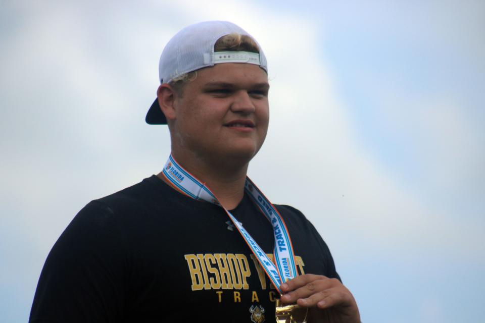 Wyatt Whalen of Bishop Verot holds his boys shot put medal at the FHSAA Class 2A high school track and field championships on May 18, 2023 in Jacksonville. [Clayton Freeman/Florida Times-Union]