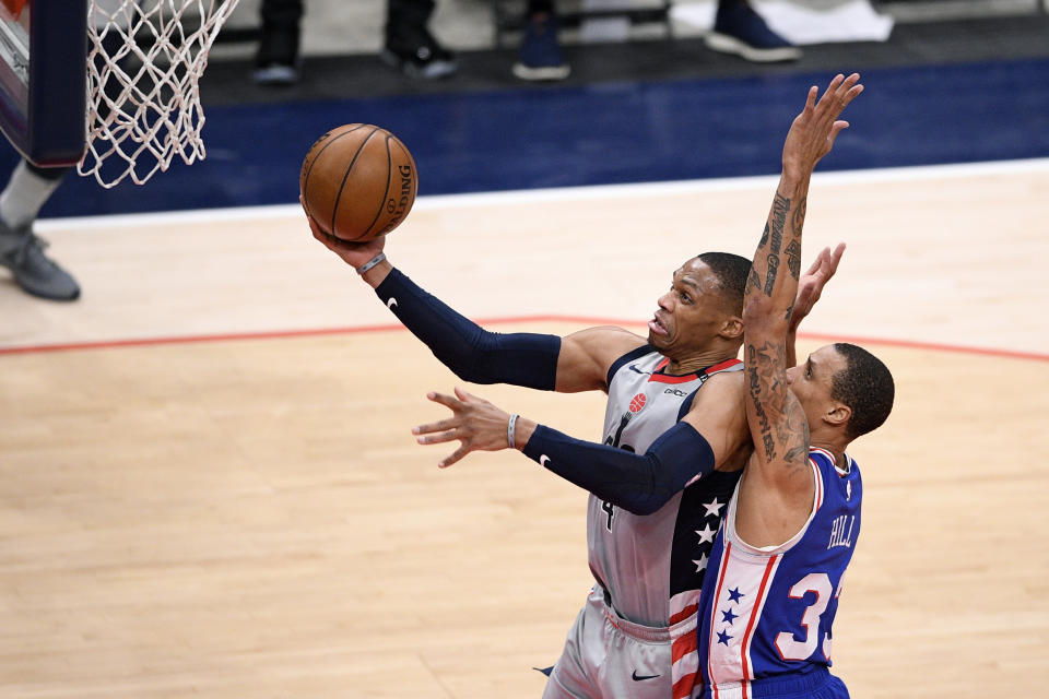 Washington Wizards guard Russell Westbrook, left, goes to the basket next to Philadelphia 76ers guard George Hill (33) during the first half of Game 4 in a first-round NBA basketball playoff series, Monday, May 31, 2021, in Washington. (AP Photo/Nick Wass)
