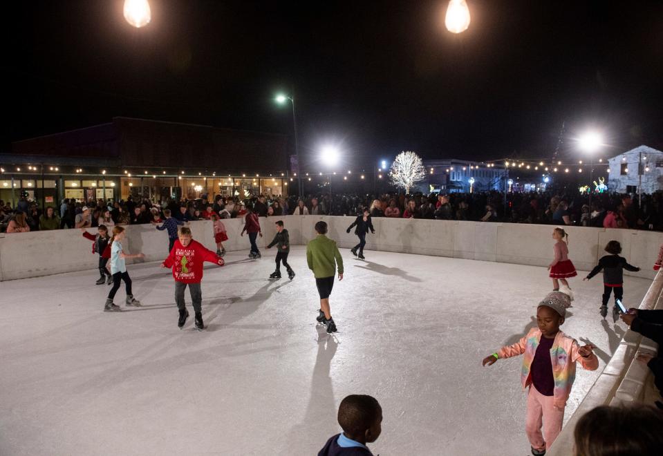 Kids skate during the Christmas Tree lighting ceremony in Prattville, Ala., on Thursday, Dec. 2, 2021.