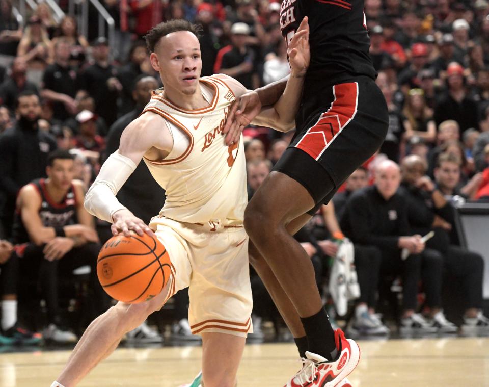 Texas' guard Chendall Weaver drives to the basketball in Tuesday's win over Texas Tech. Weaver had one of his best games of the season in the victory, and he and the Longhorns hope to carry that momentum over against Oklahoma State Saturday.