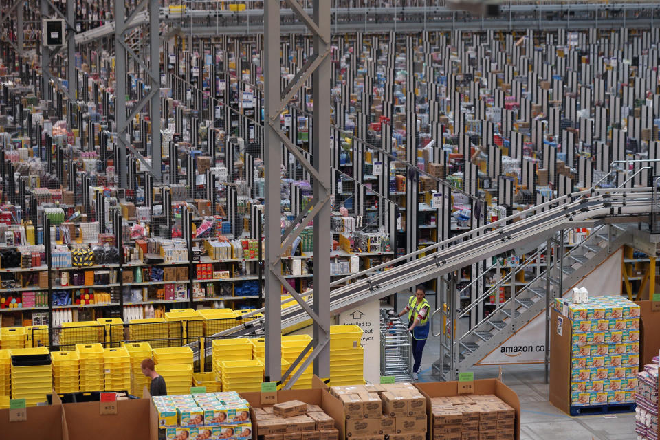 PETERBOROUGH, ENGLAND - NOVEMBER 28:  Employees select and dispatch items in the huge Amazon 'fulfilment centre' warehouse on November 28, 2013 in Peterborough, England. The online retailer is preparing for 'Cyber Monday', as it predicts the busiest day for online shopping in the UK will fall on Monday December 2nd this year. On Cyber Monday in 2012 amazon.co.uk recorded over 3.5 million individual items ordered, which equates to 41 items purchased per second. The Peterborough fulfilment centre is 500,000 sq ft, equivalent to approximately seven football pitches in floor area. Amazon are due to employ more than 1,000 seasonal staff to cope with increased demand in the run up to Christmas.  (Photo by Oli Scarff/Getty Images)