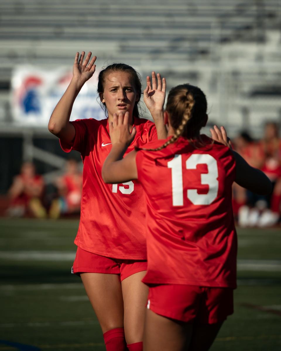 New Hartford's Anna Rayhill (15) celebrates her goal with her teammate Willa Pratt (13) at New Hartford Senior High School on Thursday, September 8, 2022. New Hartford went on to defeat Whitesboro 5-0.