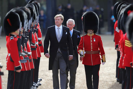 King Willem-Alexander of the Netherlands and Briain's Prince Charles, review the Honour Guard during a ceremonial welcome at the start of a state visit at Horse Guards Parade, in London, Britain October 23, 2018. Christopher Furlong/Pool via REUTERS