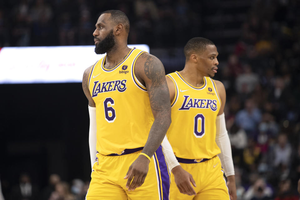 Los Angeles Lakers forward LeBron James and guard Russell Westbrook move in different directions during a game.