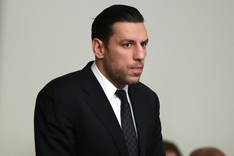 <p>Jonathan Wiggs/The Boston Globe via AP</p> Boston Bruins forward Milan Lucic, center, stands during his arraignment Tuesday, Nov. 21, 2023, in Boston Municipal Court, in Boston, on an assault charge in connection with his arrest over the weekend after his wife called police to their home and said he tried to choke her