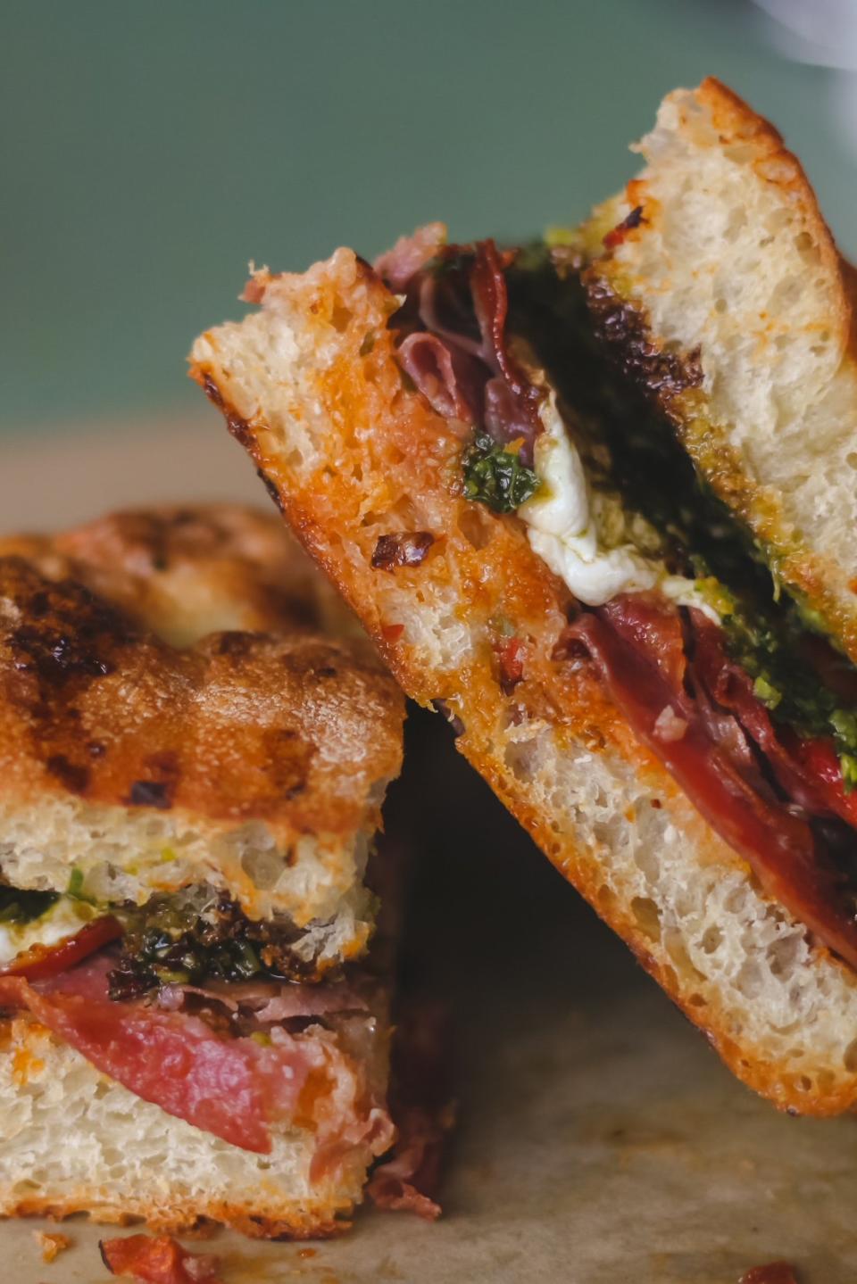 The Big Italy foccacia sandwich at The Walk-In is made with smoked meats, roasted red pepper, kale pesto, and a balsamic reduction.