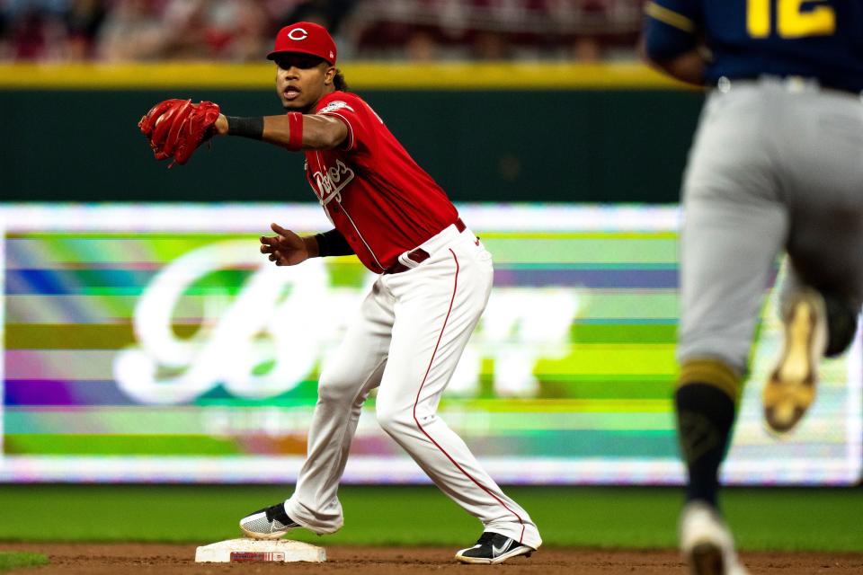 Cincinnati Reds shortstop Jose Barrero (2) catches an out as Milwaukee Brewers right fielder Hunter Renfroe (12) heads towards second in the fifth inning of the MLB game between the Cincinnati Reds and the Milwaukee Brewers at Great American Ball Park in Cincinnati on Friday, Sept. 23, 2022. 