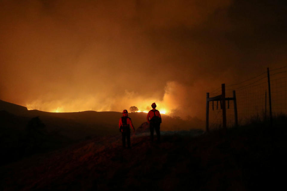 Two firefighters monitor the Kincade fire, near Geyserville, California, U.S. October 24, 2019. (Photo: Stephen Lam/Reuters)