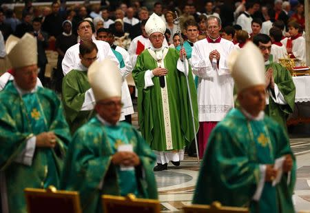 Pope Francis leaves at the end of a mass to mark the opening of the synod on the family in Saint Peter's Square at the Vatican October 5, 2014. REUTERS/Tony Gentile