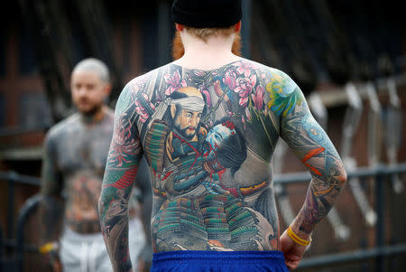 London, UK. 24th September, 2017. A man with a Japanese style body suit  tattoo, before shading and colouring has been completed, at the 13th London  International Tattoo Convention, which took place over