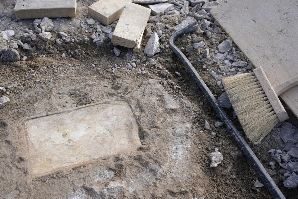 A time capsule that was placed in 1887 in the pedestal that once held the statue of Confederate General Robert E. Lee is uncovered on Monument Avenue, Friday Dec. 17, 2021, in Richmond, Va. Virginia Gov. Ralph Northam ordered the pedestal removed and the land given to the city of Richmond. (AP Photo/Steve Helber)