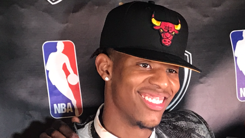 June 23, 2022; Arizona guard Dalen Terry dons a Chicago Bulls hat at his party in LoLo's Chicken and Waffles restaurant in Scottsdale after they selected him 18th overall in NBA Draft.