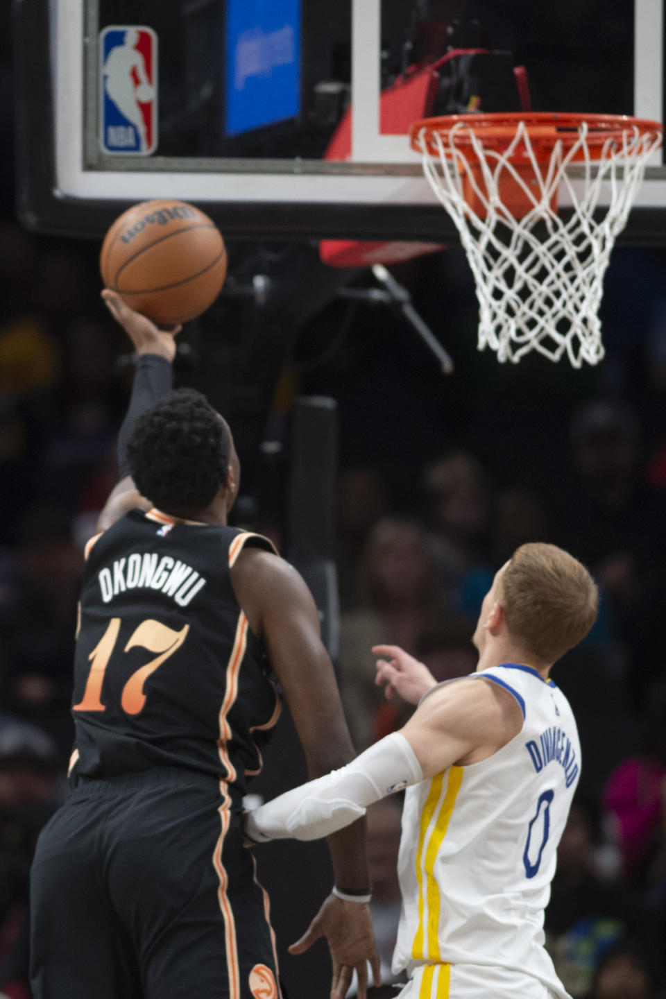 Atlanta Hawks forward Onyeka Okongwu scores past Golden State Warriors guard Donte DiVincenzo during the second half of an NBA basketball game, Friday, March 17, 2023, in Atlanta. (AP Photo/Hakim Wright Sr.)
