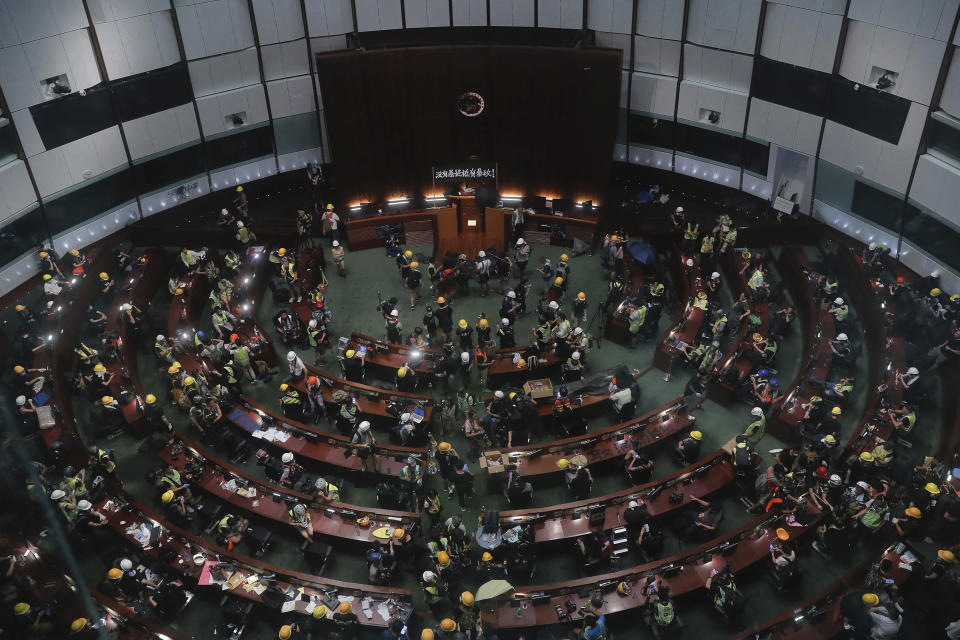 FILE - In this July 1, 2019, file photo, protesters gather inside the meeting hall after breaking in to the Legislative Council in Hong Kong. From across the political spectrum, Hong Kong residents condemned mob violence at the U.S. Capitol, 18 months after they saw protesters storm their own local legislature. (AP Photo/Kin Cheung, File)