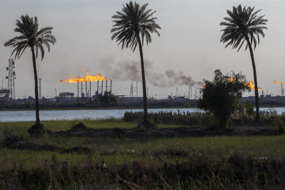 The Nihran Bin Omar oil field flare stacks burn north of Basra, Iraq, Wednesday, March 22, 2023. In the wake of the US invasion of Iraq in 2003 and toppling of Saddam Hussein, foreign investors flocked to the country's abundant oil fields and contracts were doled out, filling Iraqi state coffers. The new constitution drafted in 2005 states that the country's oil wealth belongs to the Iraqi people. (AP Photo/Nabil al-Jurani)