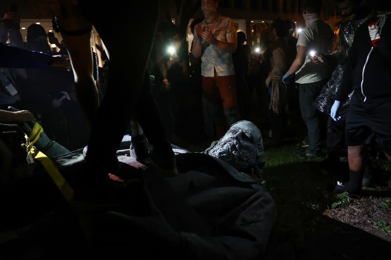 Protesters topple a statue of Albert Pike amid demonstrations and events on Juneteenth, which commemorates the end of slavery in Texas, in Washington