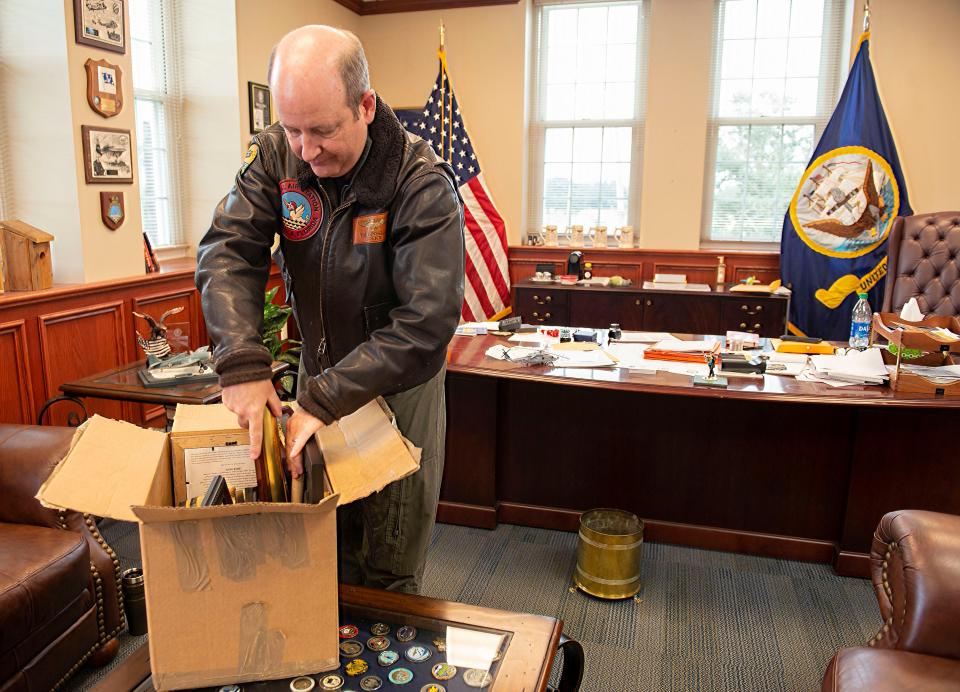 Capt. Tim Kinsella, then the commanding officer of NAS Pensacola, packs up his personal items Jan. 6 as he prepares to turn over the office to Capt. Terrence Shashaty. Kinsella will receive the 2021 FBI Director's Community Leadership Award for his work in the community in the wake of the 2019 terrorist attack on the base.