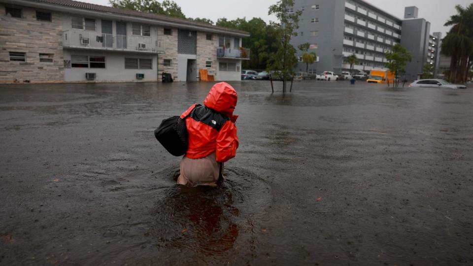 PHOTO: A person walks through a flooded street, June 12, 2024, in Hollywood, Fla. (Joe Raedle/Getty Images)