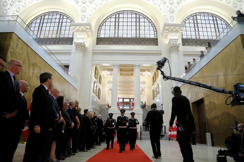 Members of Parliament watch a ceremonial procession before the speech from the throne in Ottawa