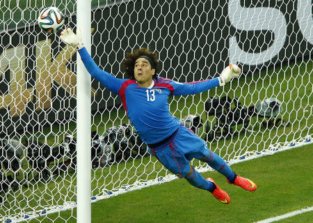 Mexico's Guillermo Ochoa jumps to save the ball. REUTERS/Mike Blake