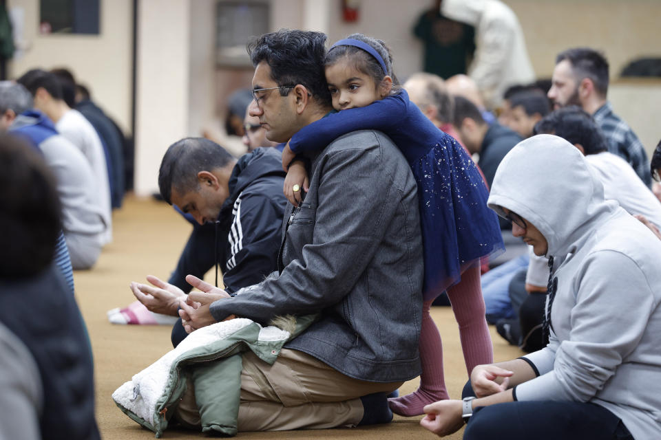 Yasir Nawaz's daughter, Amal, 4, clings to him during Friday prayers, Friday, Oct. 13, 2023, at the Islamic Center of East Lansing in East Lansing, Mich. In Muslim communities across the world, worshippers gathered at mosques for their first Friday prayers since Hamas militants attacked Israel, igniting the ongoing Israel-Hamas war. (AP Photo/Al Goldis)
