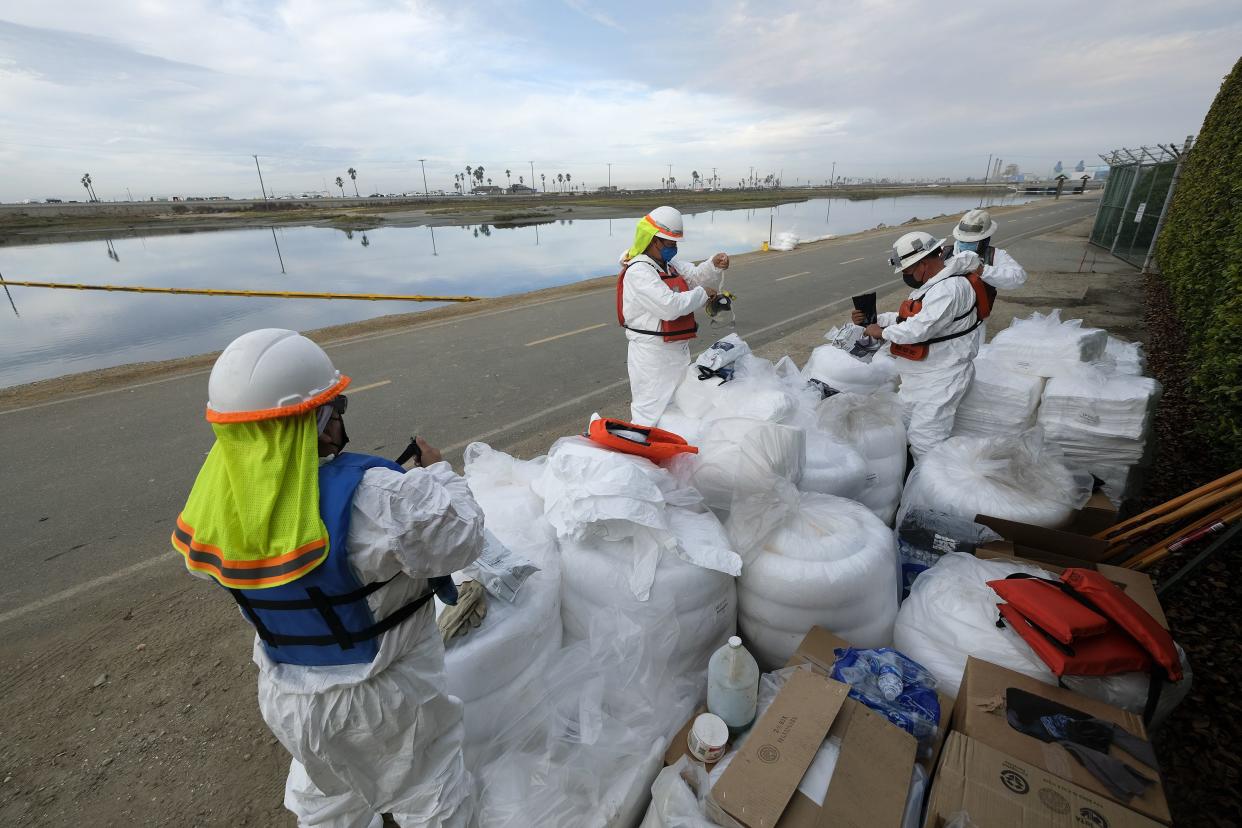 Cleanup contractors get ready to work in the Wetlands Talbert Marsh after an oil spill in Huntington Beach, Calif. on Monday, Oct. 4, 2021.