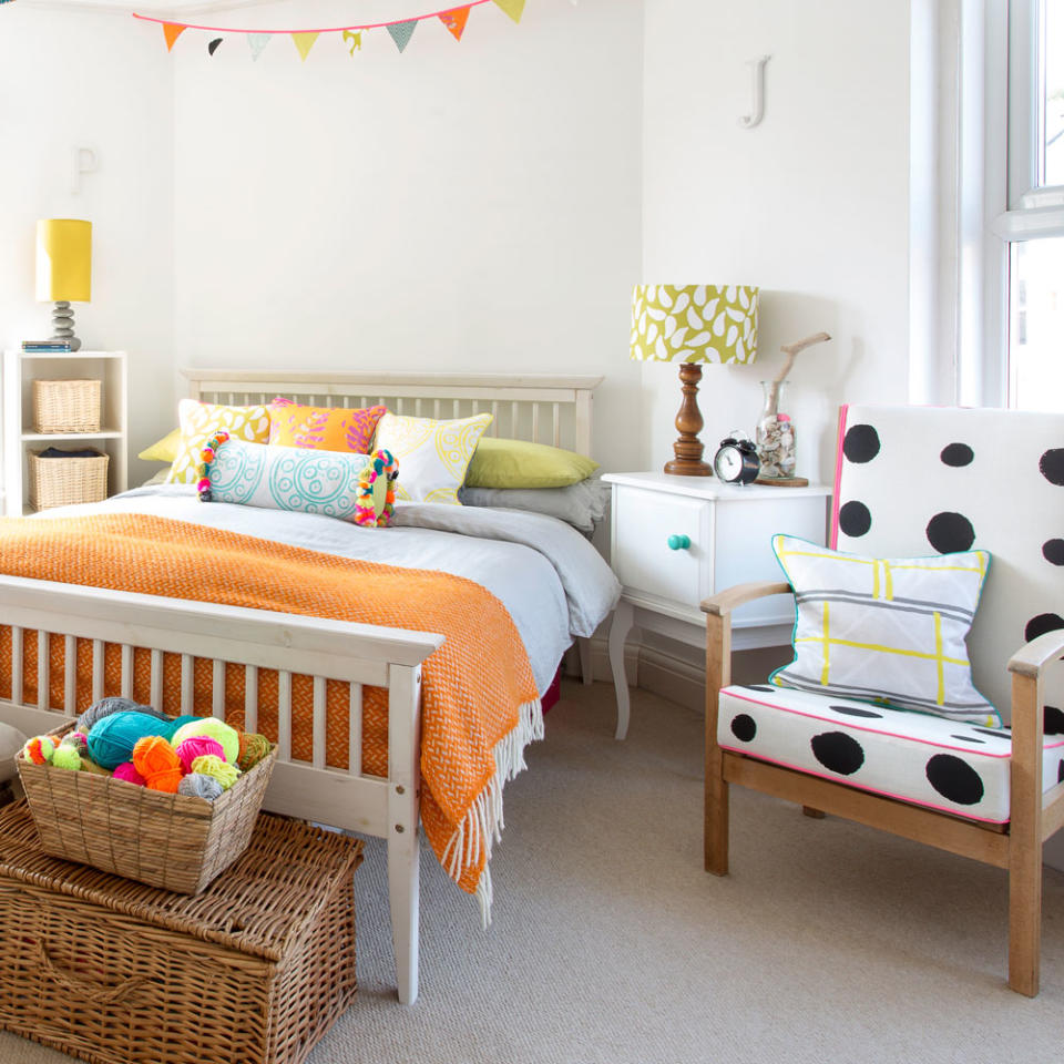 white bedroom with bed and armchair