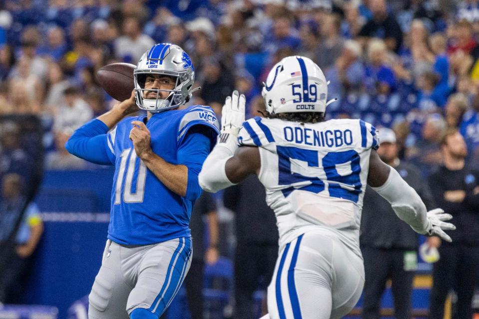 Lions quarterback David Blough passes the ball while Colts defensive end Ifeadi Odenigbo defends in the second quarter of a preseason game at Lucas Oil Stadium, Aug. 20, 2022.