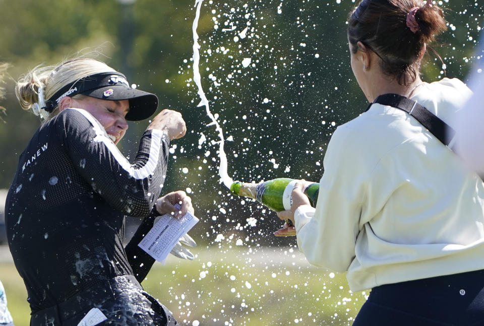 Charley Hull, left, of England, is doused after winning the LPGA The Ascendant golf tournament in The Colony, Texas, Sunday, Oct. 2, 2022. (AP Photo/LM Otero)