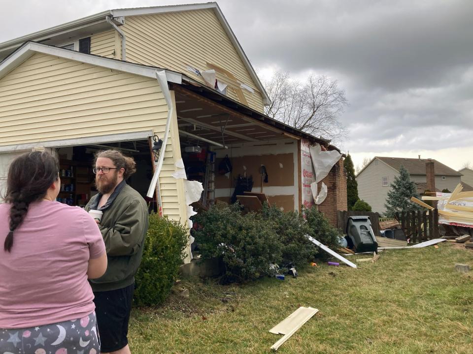 Carole and Andrew Essex stand outside their destroyed garage and chimney on Oldwynne Road in Hilliard on Wednesday that was damaged by an EF1 tornado, according to the National Weather Service in Wilmington.