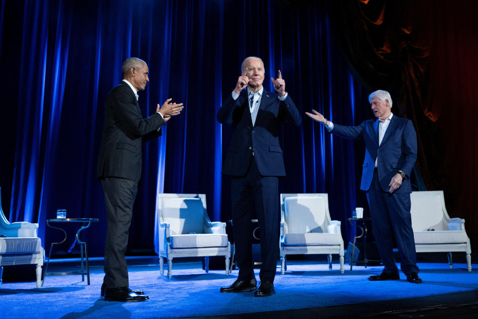 Former US President Barack Obama (L) and former US President Bill Clinton (R) cheer for US President Joe Biden during a campaign fundraising event at Radio City Music Hall in New York City on March 28, 2024. (Photo by Brendan Smialowski / AFP) (Photo by BRENDAN SMIALOWSKI/AFP via Getty Images)