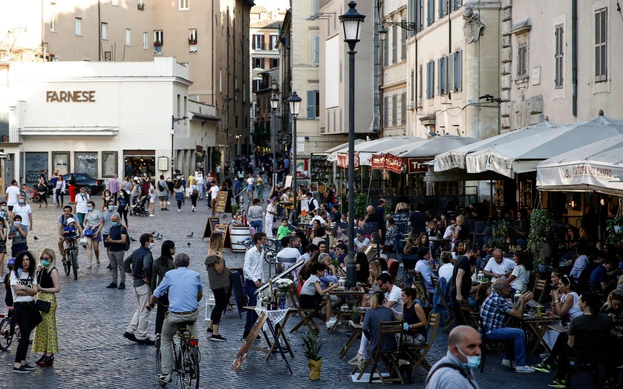 People socialise in Campo de Fiori, a popular piazza in Rome's historic centre - LaPresse