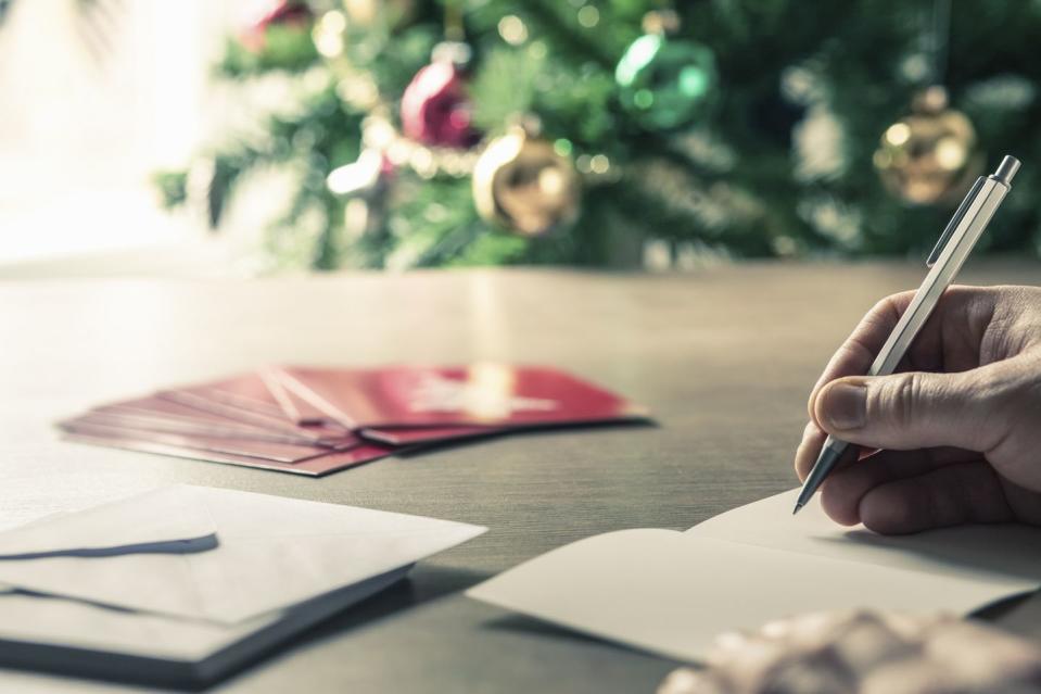 Person writing christmas cards