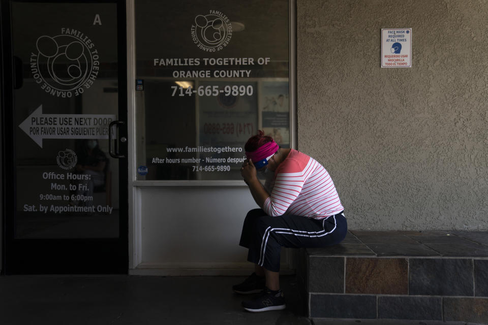 Ana Aguirre, 50, who said she was experiencing COVID-19 symptoms, waits to get tested for the virus at Families Together of Orange County Thursday, Aug. 26, 2021, in Tustin, Calif. (AP Photo/Jae C. Hong)