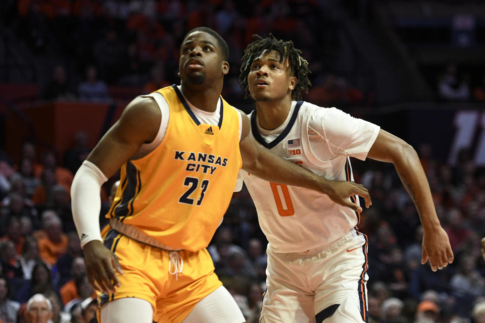 Kansas City's Allen David Mukeba Jr. (23) and Illinois' Terrence Shannon Jr. look to rebound during the first half of an NCAA college basketball game Friday, Nov. 11, 2022, in Champaign, Ill. (AP Photo/Michael Allio)