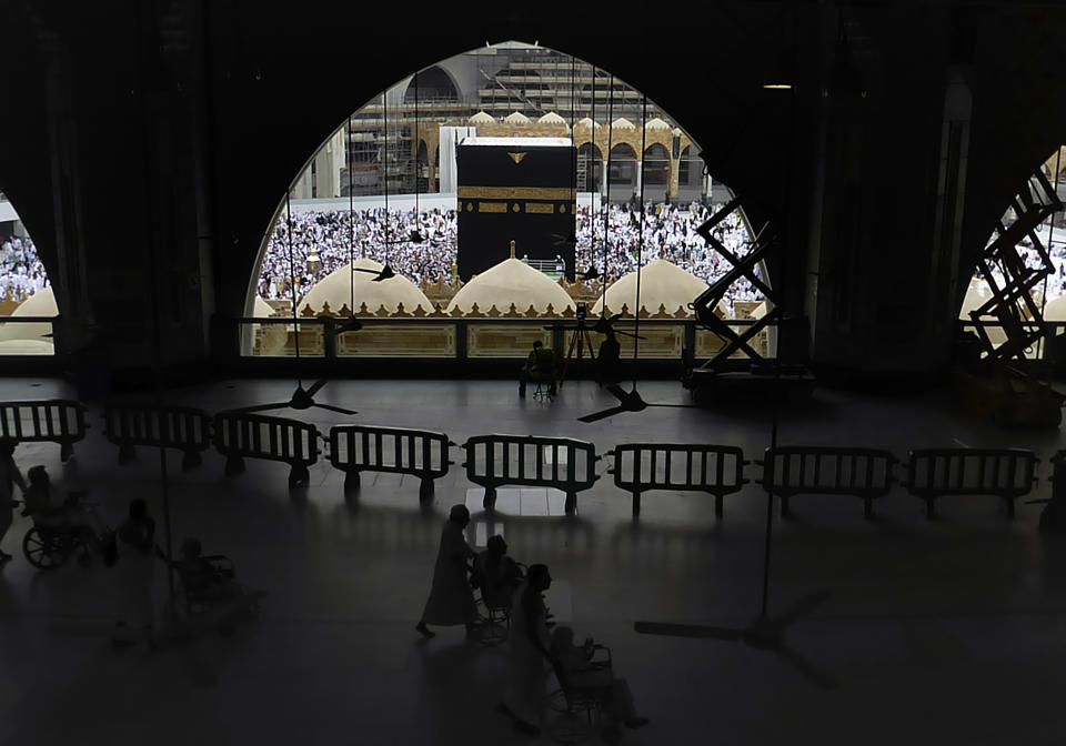 In this Monday, Feb. 24, 2020, photo, Muslim pilgrims circumambulate around the Kaaba, the cubic building at the Grand Mosque, during the minor pilgrimage, known as Umrah in the Muslim holy city of Mecca, Saudi Arabia. Saudi Arabia on Thursday, Feb. 27, 2020, halted forei to the holiest sites in Islam over fears about a new viral epidemic just months ahead of the annual hajj pilgrimage. (AP Photo/Amr Nabil)