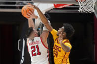 Utah forward Dusan Mahorcic (21) shoots as Southern California forward Joshua Morgan (24) defends in the first half during an NCAA college basketball game Saturday, Jan. 22, 2022, in Salt Lake City. (AP Photo/Rick Bowmer)