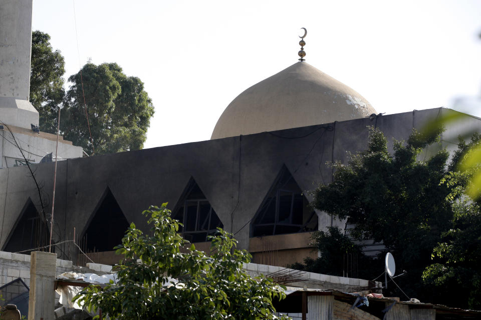 A mosque burnt in yesterday's explosion in the Burj Shamali Palestinian refugee camp, in the southern port city of Tyre, Lebanon, Saturday, Dec. 11, 2021. Arms stored for the Palestinian Hamas group exploded in a refugee camp in southern Lebanon on Friday night, killing and wounding a number of people, the state-run National News Agency reported. (AP Photo/Mohammed Zaatari)