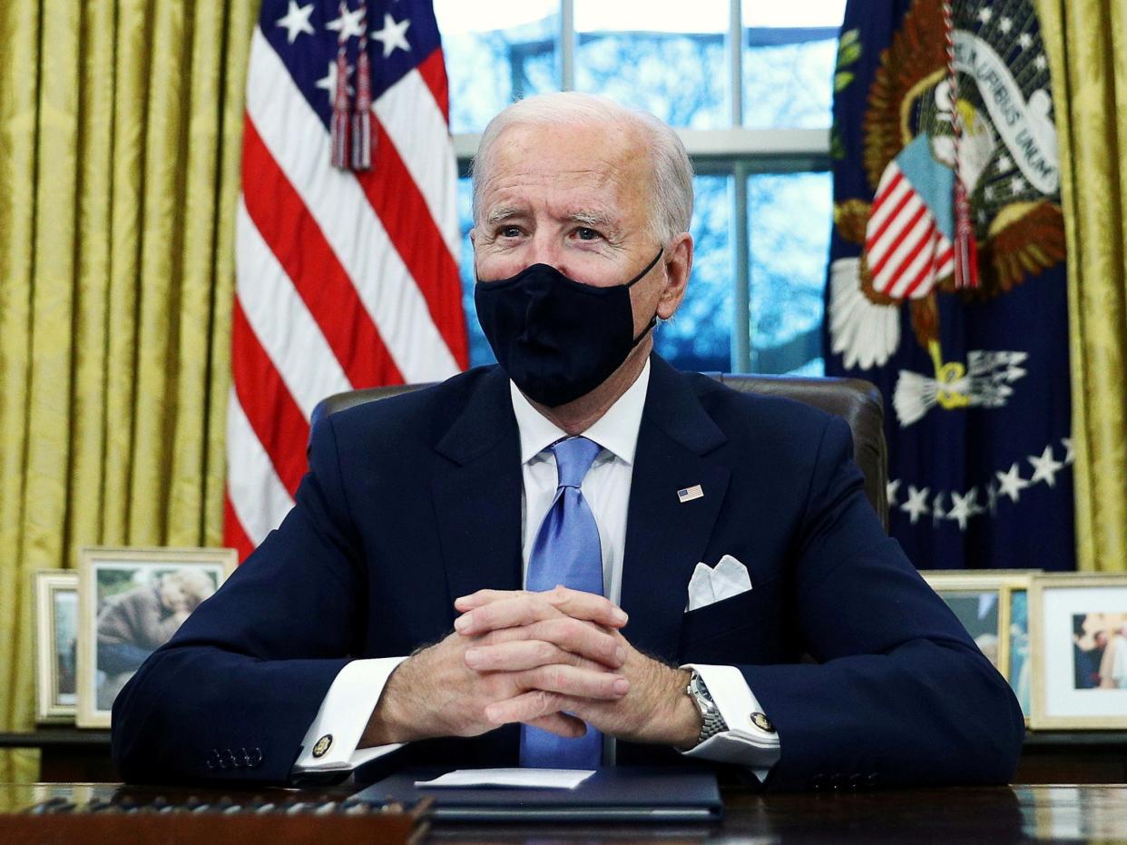 <p>President Joe Biden signs executive orders in the Oval Office of the White House in Washington, after his inauguration as the 46th President of the United States. </p> (REUTERS)