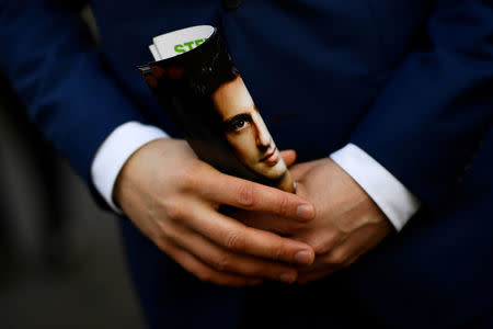 Dutch Green Party (Groen Links) leader Jesse Klaver holds a leaflet showing his face while campaigning outside a train station in Leiden, Netherlands March 14, 2017. REUTERS/Dylan Martinez