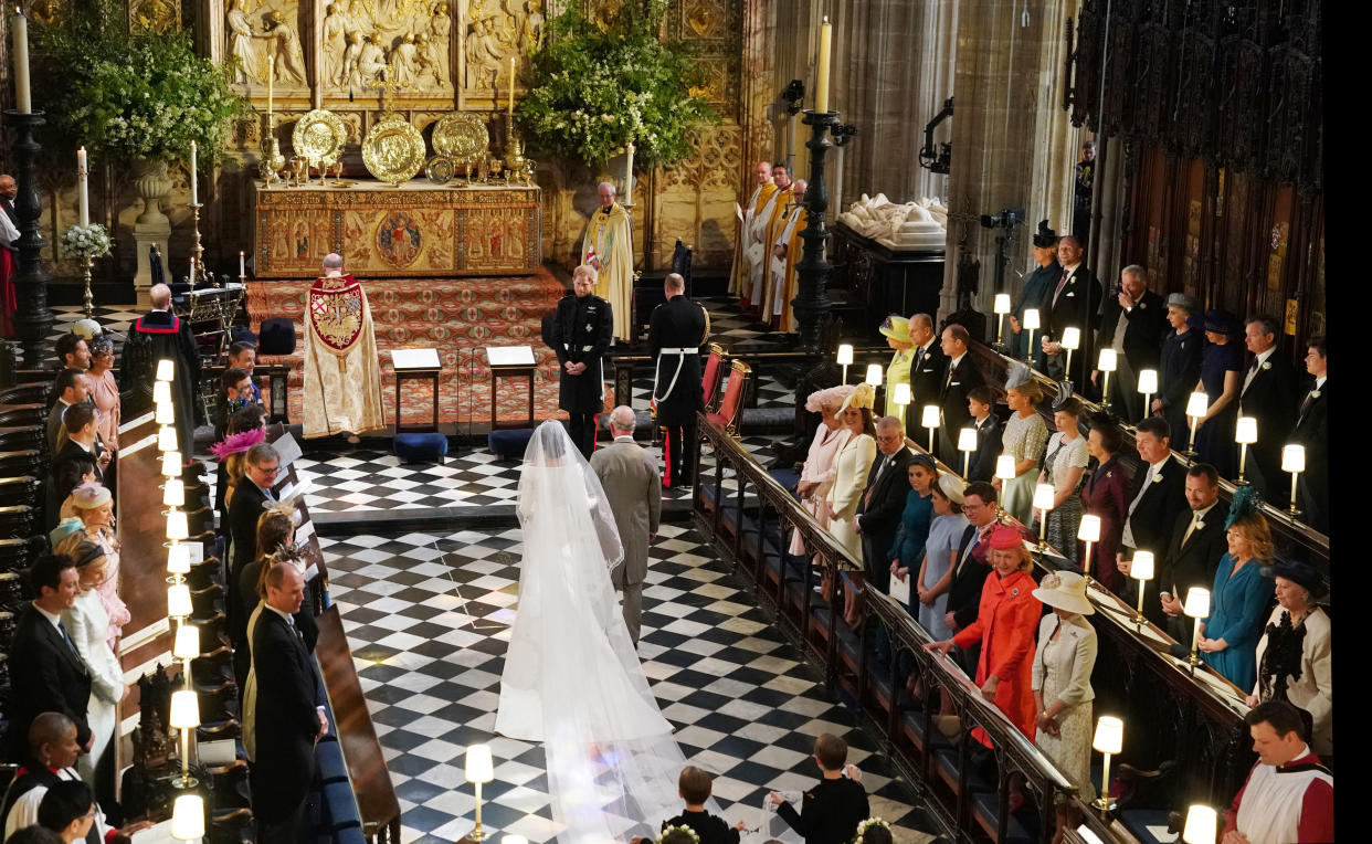 WINDSOR, UNITED KINGDOM - MAY 19:  Prince Harry looks at his bride, Meghan Markle, as she arrived accompanied by Prince Charles, Prince of Wales during their wedding in St George's Chapel at Windsor Castle on May 19, 2018 in Windsor, England. (Photo by Owen Humphreys - WPA Pool/Getty Images)