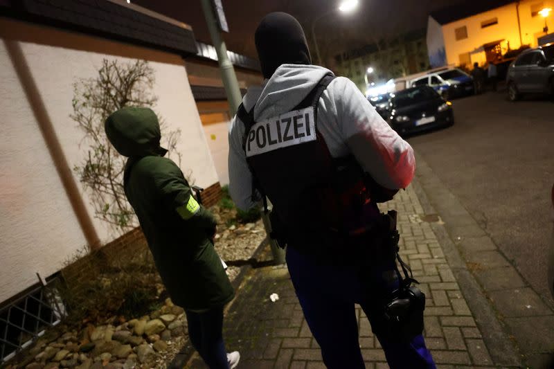 Police officers search an area after a shooting in Hanau near Frankfurt