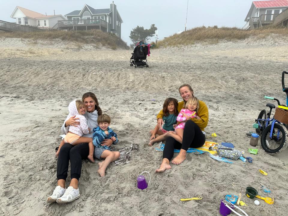 Surf City residents Alex Kindred, left, and Ann Chui, right, regularly bring their children to the beach to play during the day. Kindred said they enjoy the small family-owned businesses and shops in Surf City.