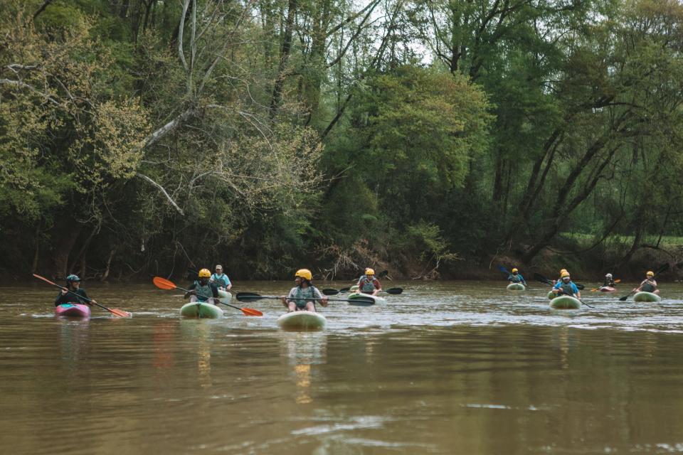 A group of kayakers paddle the South Fork River between Spencer Mountain and McAdenville.