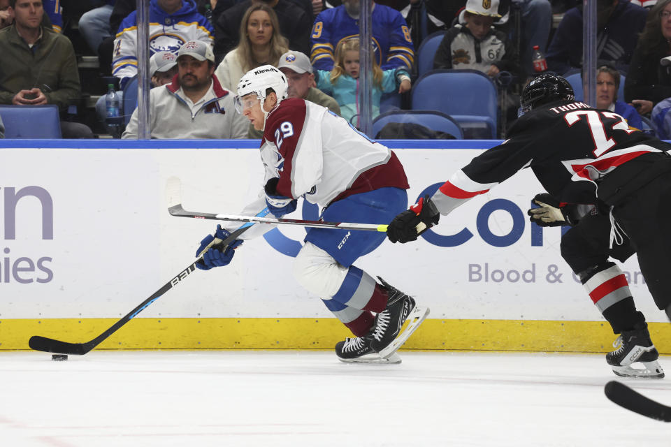 Colorado Avalanche center Nathan MacKinnon (29) is pressured by Buffalo Sabres right wing Tage Thompson (72) during the second period of an NHL hockey game, Sunday, Oct. 29, 2023, in Buffalo, N.Y. (AP Photo/Jeffrey T. Barnes)